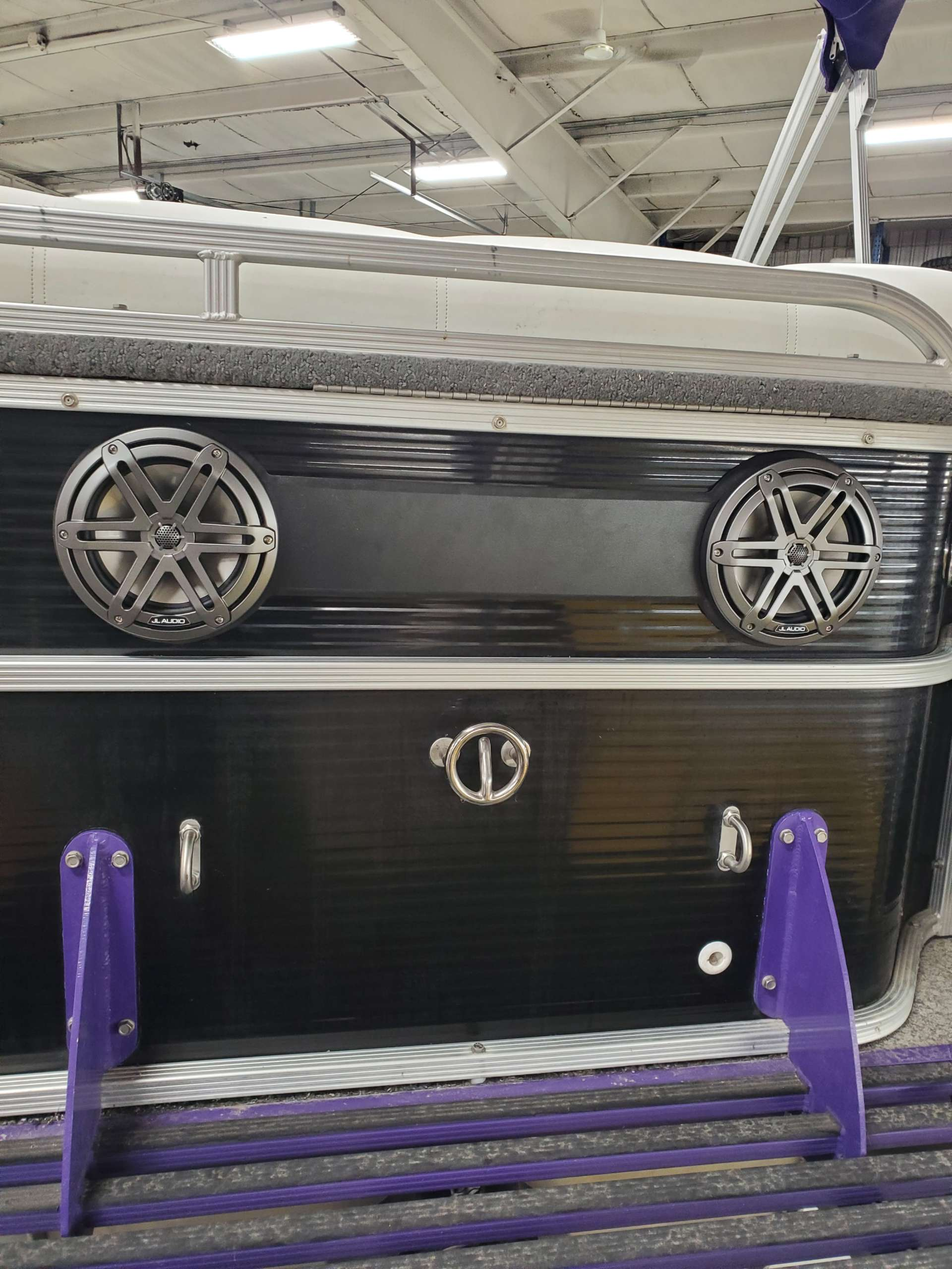 Large marine speakers integrated into the side of a pontoon